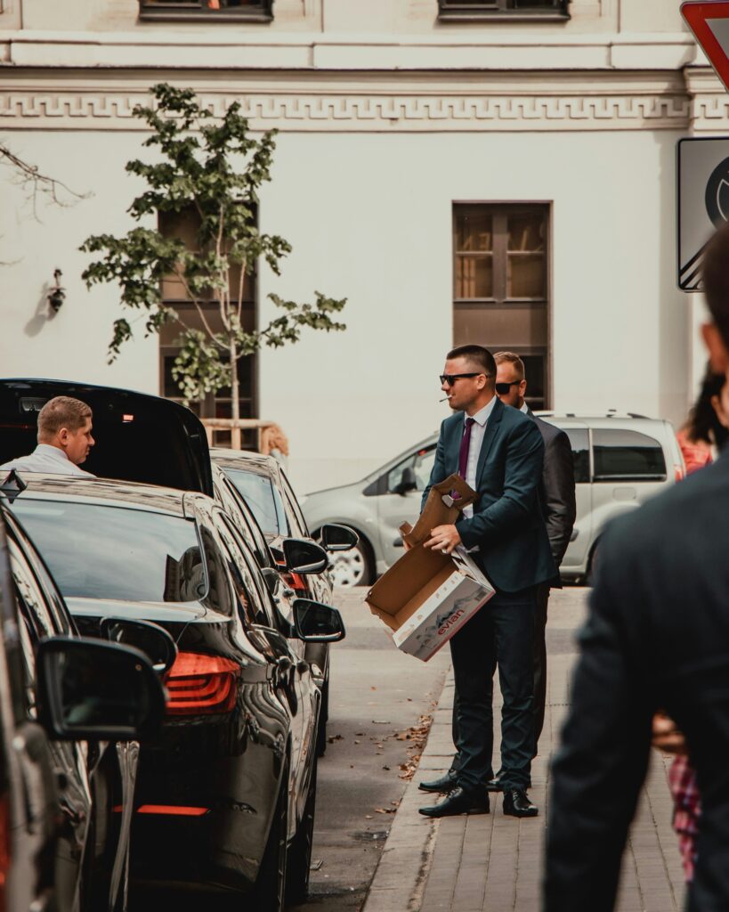 Business traveller arriving beside a waiting car