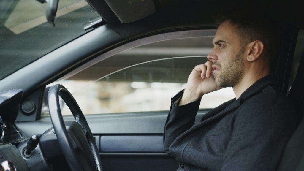 Executive taking a phone call in the back of a car