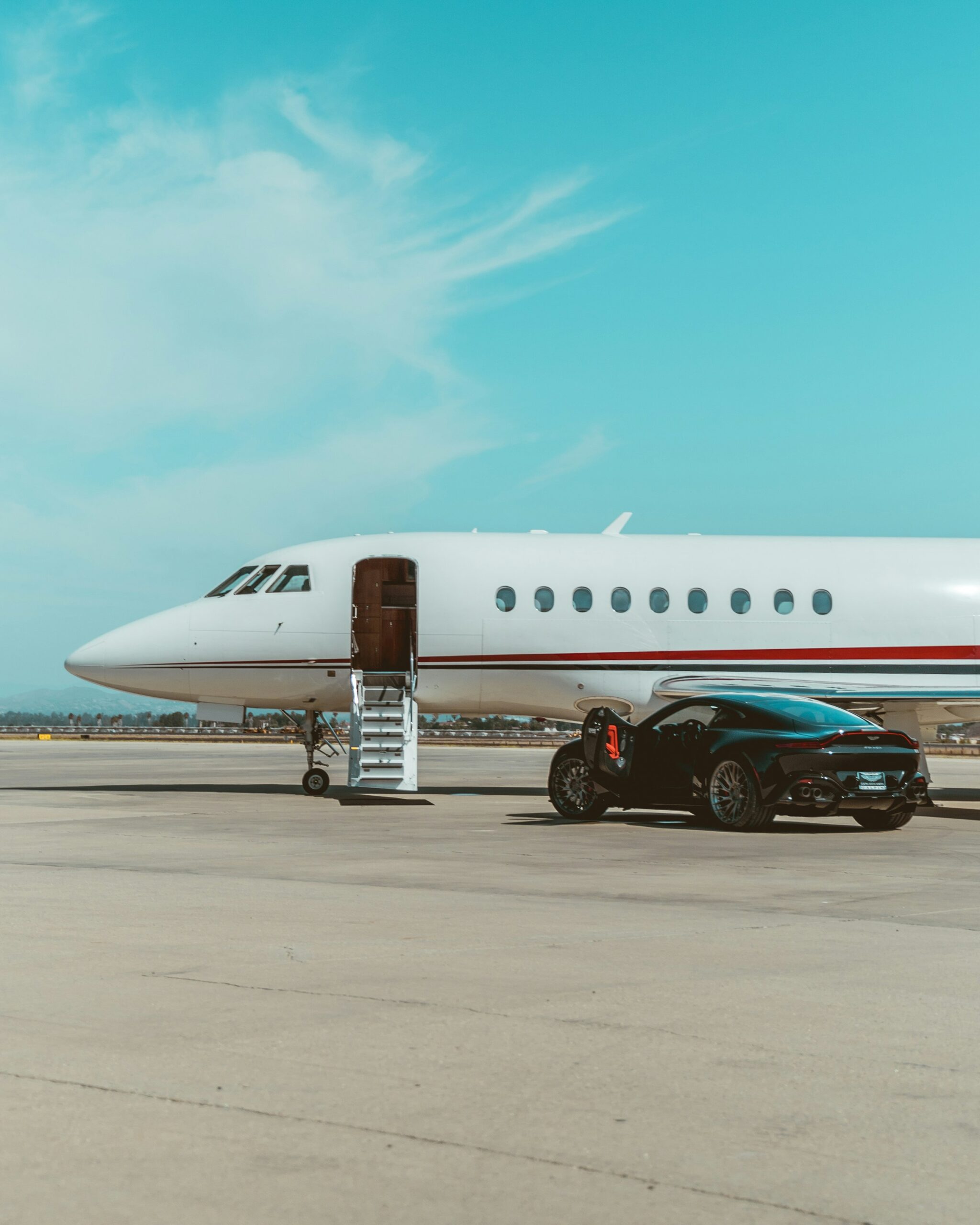 Private jet on the tarmac with a car waiting beside it